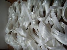 many white ribbons are stacked on top of each other