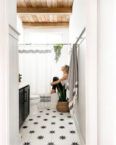 a woman sitting on a toilet in a bathroom