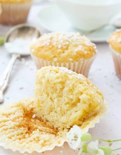 cupcakes with powdered sugar on top and spoon next to them, ready to be eaten