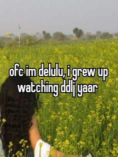 a woman sitting in a field with the words off im delluy i grew up watching