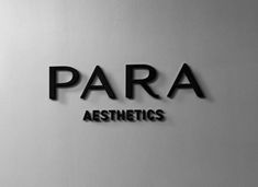 the logo for para aesthetics is displayed on a wall in black and white colors