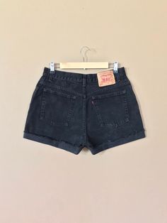 "High waisted 90's denim shorts. Made by Levi's in classic black denim wash. Shorts are in excellent clean condition. Perfectly worn in with light naturally distressed character. These have been cut off and washed once. Measurements are taken zipped or buttoned up and laid comfortably flat then x 2 for total circumference (inches) Tag Size 14 Reg Levis 550 100% Cotton ~Measure Rise First~ Waist 31\" Hips 44\" Length 15\" Inseam 4\" Rise 12\" leg opening circumference 25\" All items are free of r Grunge Jean Shorts With Built-in Shorts, Cutoff Shorts With Belt Loops For Streetwear, 90s Style Shorts With Belt Loops, Grunge High Waist Jean Shorts With Built-in Shorts, Grunge Style Relaxed Fit Cotton Jean Shorts, Grunge Relaxed Fit Cotton Jean Shorts, Grunge Cotton Relaxed Fit Jean Shorts, Grunge Style Relaxed Fit Jean Shorts, Grunge Cotton Jean Shorts With Relaxed Fit