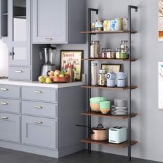 a kitchen with gray cupboards and shelves filled with various items on the counter top