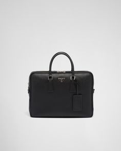 Black Saffiano Leather Briefcase | PRADA Modern Travel Bags With Logo Plaque, Designer Briefcase With Detachable Strap, Luxury Black Briefcase With Zipper Closure, Classic Business Bag With Logo Plaque, Black Business Bag With Logo Plaque, Black Travel Bags With Logo Plaque, Designer Leather Briefcase With Zipper Closure, Modern Briefcase With Zipper Closure For Formal Use, Black Leather Bags With Logo Plaque