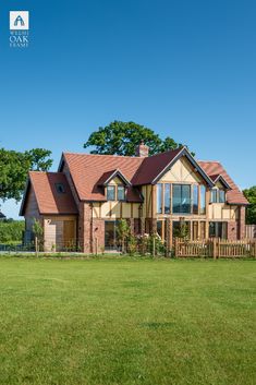 a large house sitting on top of a lush green field