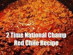 the words, 2 time national champ red chili recipe are in front of a skillet full of chili