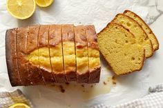 a loaf of lemon pound cake next to slices of bread