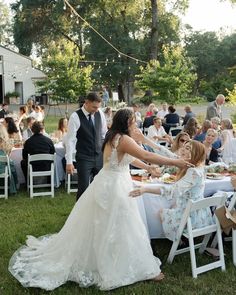 the bride and groom are getting ready to eat their guests at this outdoor wedding reception