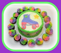 a birthday cake decorated with roller skates and cupcakes