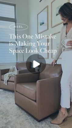 a woman sitting on top of a brown couch in a living room