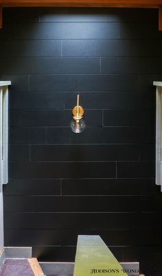 an empty room with black walls and wood trimmings on the wall is shown