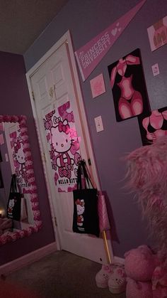 a hello kitty themed bedroom decorated in pink and black with pictures on the wall above it