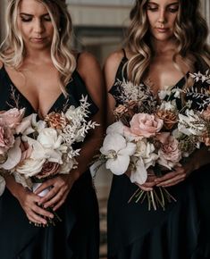 two women in black dresses holding bouquets of flowers