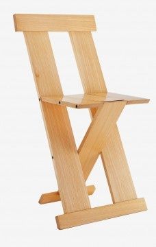 a wooden folding chair sitting up against a white background