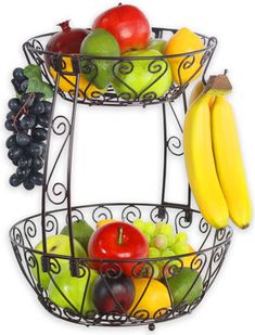 two tiered metal fruit basket with bananas, apples, and grapes on each side