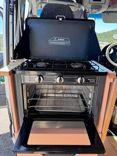 an open oven in the back of a van