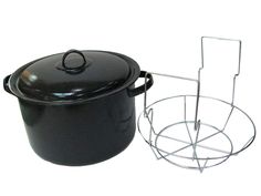 a black pot with a wire holder next to it