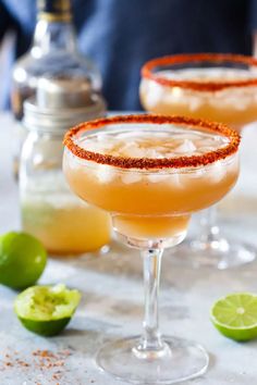 two margaritas sitting next to each other on a table