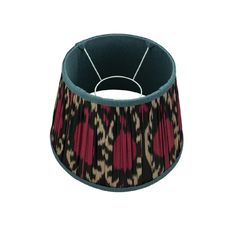 a lamp shade with red and black designs on it