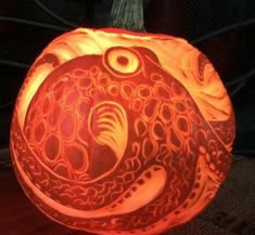 a pumpkin carved to look like a fish with an octopus on it's head