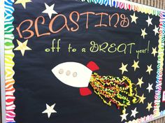 a bulletin board with a rocket ship on it