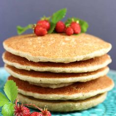 a stack of pancakes with strawberries on top