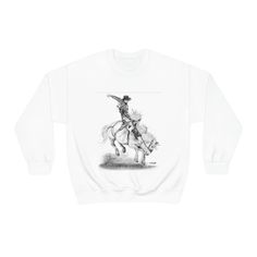 Unisex Heavy Blend Crewneck Sweatshirt - Rodeo Bronc Busting Cowboy Horse Riding Original Artwork from Dantel Art LLC  Ideal for any situation, a unisex heavy blend crewneck sweatshirt is pure comfort. These garments are made from polyester and cotton. This combination helps designs come out looking fresh and beautiful. The collar is ribbed knit, so it retains its shape even after washing. There are no itchy side seams on these sweaters.  .: 50% cotton, 50% polyester .: Medium-heavy fabric (8.0 Horse Riding Illustration, Cowboy Horse, Horse Riding, Sew-in Labels, Rodeo, Crewneck Sweatshirt, Sweat Shirt, Ribbed Knit, Original Artwork