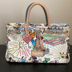 Disney Dooney & Bourke Purse With Strap. In Great Condition With Minimal Wear And Tear (Cracking Of The Leather On One Of The Handles, Look At The Picture For Reference). Dooney And Bourke Disney, Disney Dooney, Disney Sketches, Leather Label, Tinker Bell, Dooney Bourke Handbags, Dooney & Bourke Bags, Dooney & Bourke, Satchel Handbags