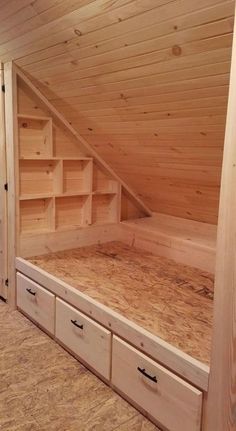 an unfinished bed frame with storage drawers in the bottom and upper bunk area on one side