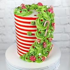 a cake decorated with candy canes and green icing