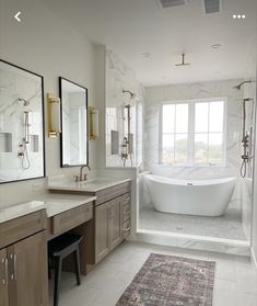 a bath room with a tub a sink and mirrors