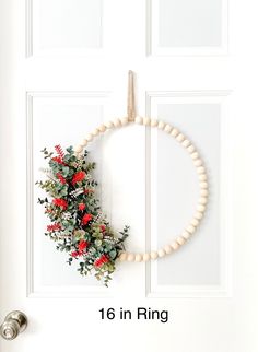 a white door with a wreath on it and the numbers 1 - 6 in ring