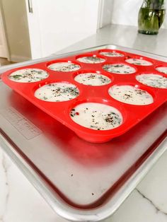 a red tray filled with muffins on top of a counter