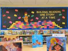 children's books are displayed in front of a bulletin board that reads building readers one story at a time