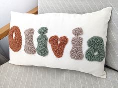 a pillow with the word love spelled out in crochet