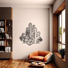 a living room filled with furniture and a cactus wall decal