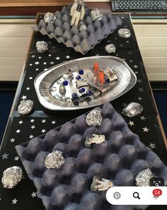 a table topped with trays filled with different types of items