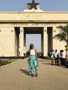 a woman standing in front of a building with a star on it