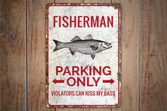 a sign that says fisherman parking only violators can kiss my bass