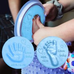 a baby's hand and foot prints are being held in front of the child's hands