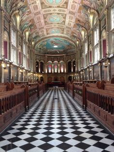 an ornately decorated church with black and white checkered flooring