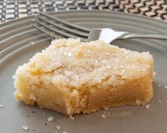 a piece of cake sitting on top of a plate next to a knife and fork