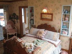 a bed room with a neatly made bed next to a dresser and window sill