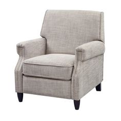 the arm chair is upholstered with studding on the arms and legs, along with