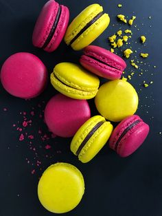 colorful macaroons and confetti on a black surface