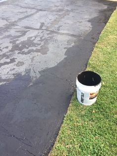 a white bucket sitting on the side of a road