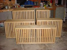 four wooden benches sitting next to each other in a room