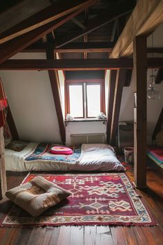 there are two beds in the attic with pillows on them