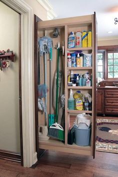 an open closet filled with cleaning supplies and other items