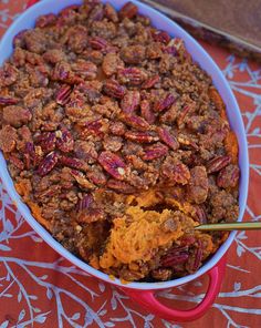 a large casserole dish with pecans and other toppings in it on a table